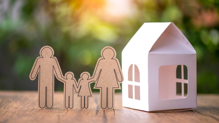 Family paper cut with model house on the table