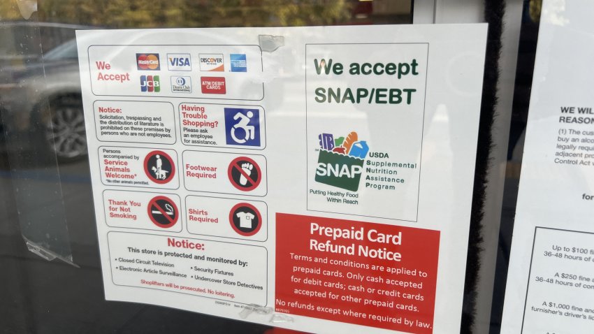 Sign advertising We Accept SNAP and EBT, referring to the Supplemental Nutrition Assistance Program and Electronic benefit transfer, in window of a store in Lafayette, California, November 4, 2025. (Photo by Smith Collection/Gado/Getty Images)