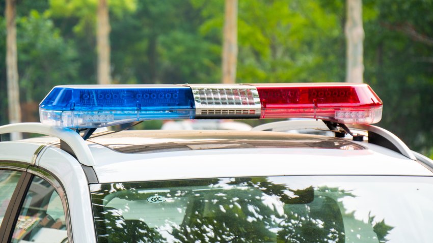 Police lights on car during traffic surveillance on the city road. Flash light on the vehicle of the Emergency Services. Red and blue flashes on the cars of the Patrol specialized unity.