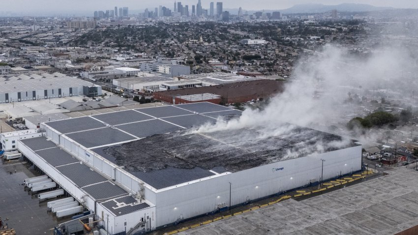 The roof continued to smolder at a Lineage Logistics cold storage facility in Boyle Heights on Thursday, June 18, 2026.