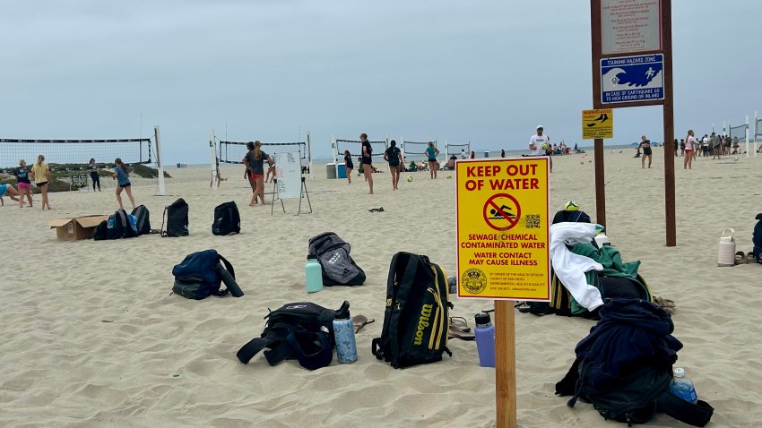 Signs warning people to stay out of the water were posted near the volleyball area on Coronado Beach, Saturday, June 6, 2026.