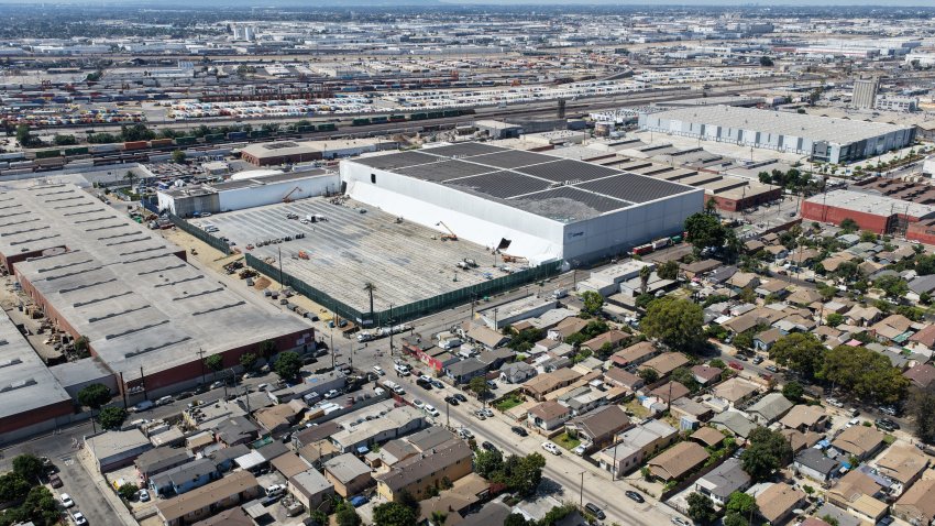 An aerial view of the neighborhood surrounding the building as crews continuing cleanup efforts following a large fire earlier this summer at Lineage Cold Storage Solutions in Boyle Heights on Friday, Aug. 14, 2026.