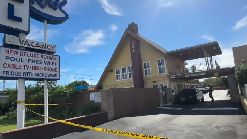 Crime scene tape is pictured in front of an Anaheim motel.
